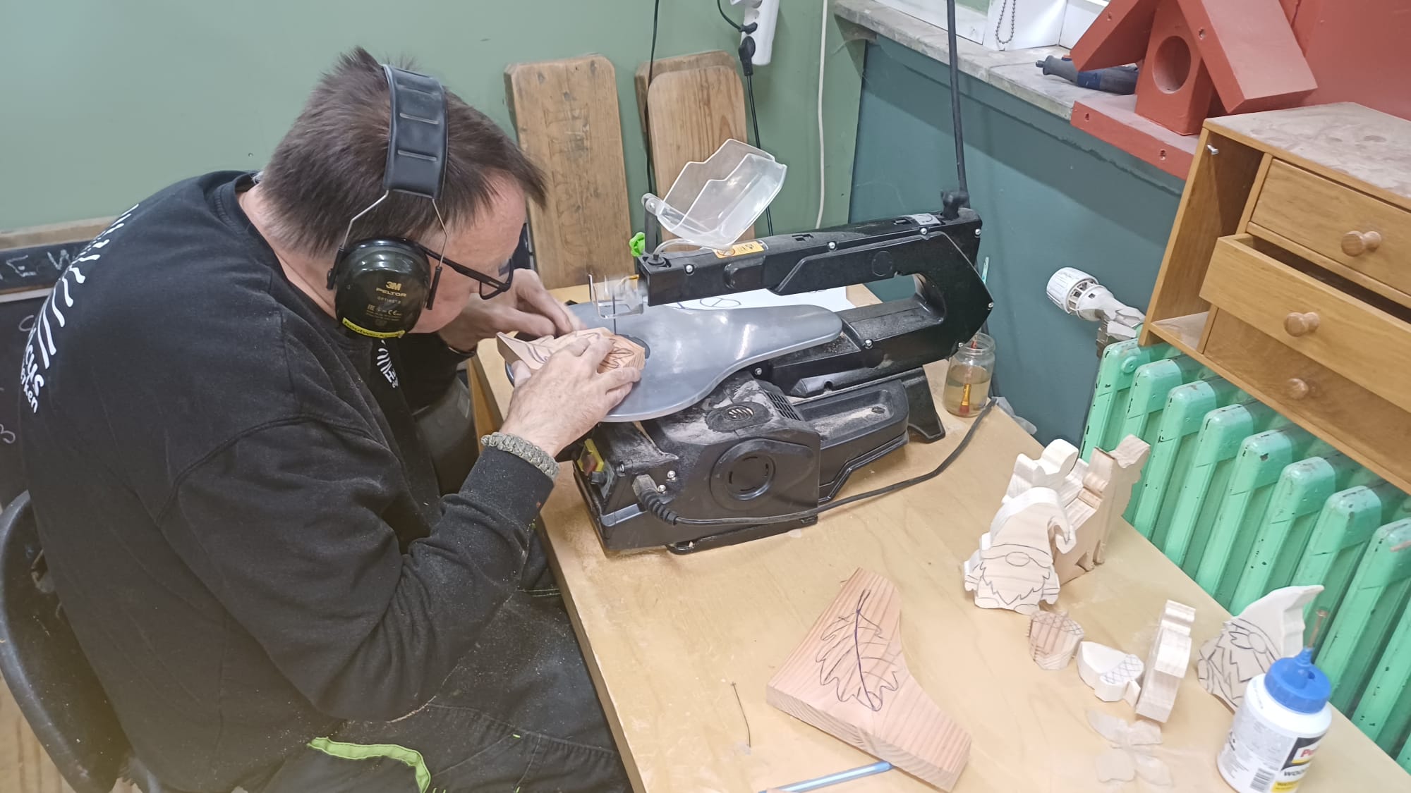 Met aandacht een houten werkstuk figuurzagen